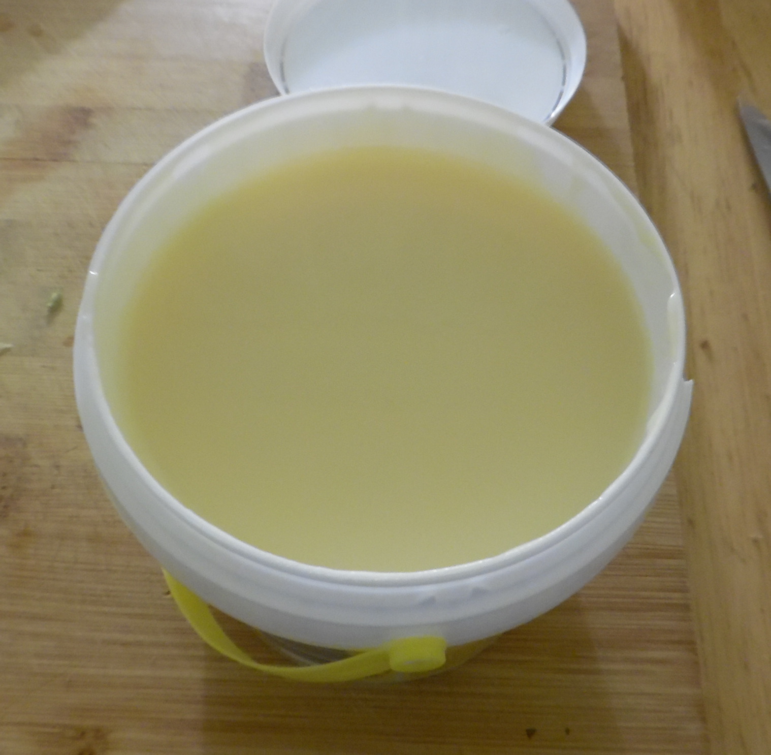 Opened bucket of sweetened condensed milk. Opened bucket of sweetened condensed milk.